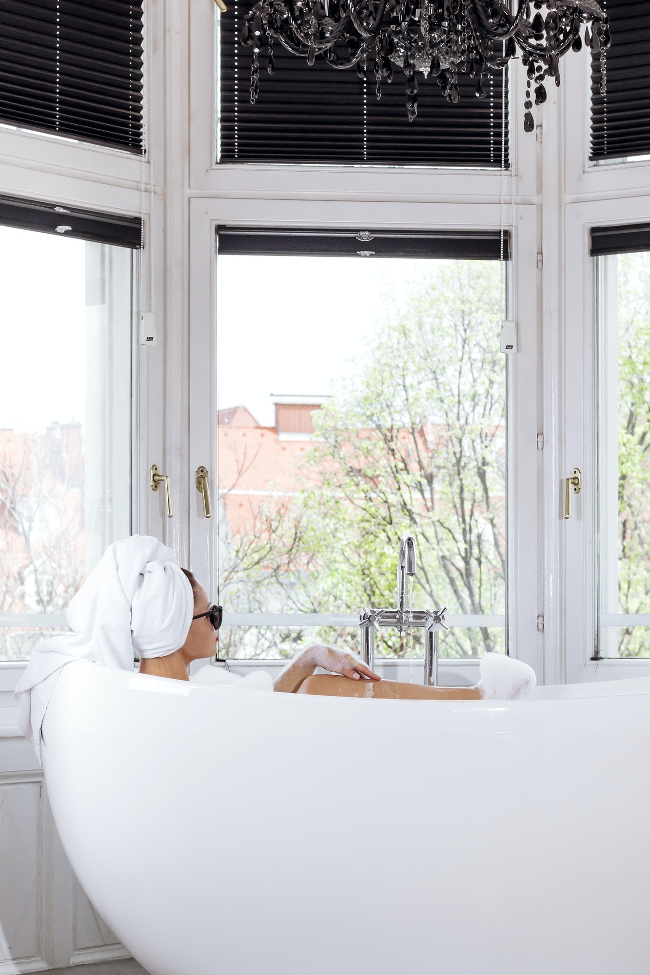 young woman takes a bath in a luxury hotel room